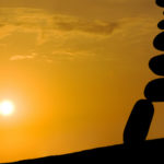 mountain sunset, zen rocks pyramid with meditor